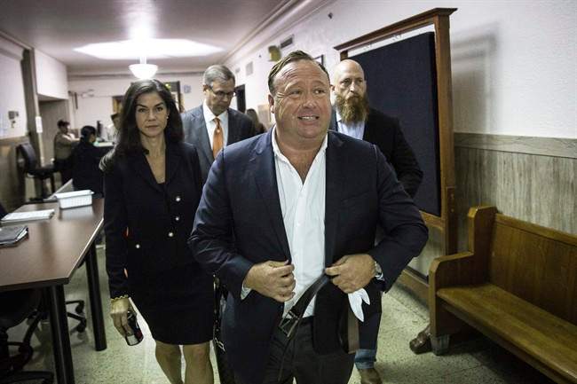 In this Monday, April 17, 2017 photo, "Infowars" host Alex Jones arrives at the Travis County Courthouse in Austin, Texas.