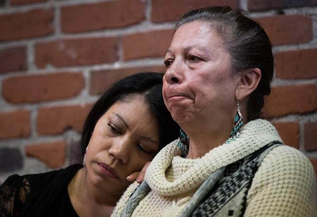 Lorelei Williams, left, rests her head on Michelle Pineault's shoulder as they listen during a Coalition on Missing and Murdered Indigenous Women and Girls news conference, in Vancouver, B.C., on Monday April 3, 2017.