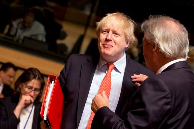 FILE - British Foreign Secretary Boris Johnson, left, speaks with Luxembourg's Foreign Minister Jean Asselborn during a meeting of EU foreign ministers at the EU Council building in Luxembourg on Monday, April, 2017.