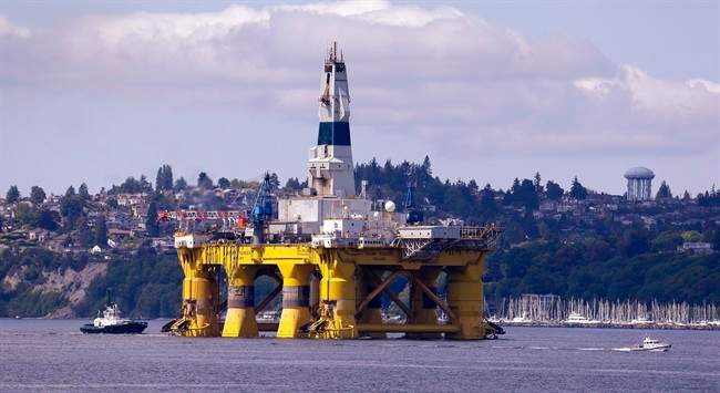 In this May 14, 2015 file photo, the oil drilling rig Polar Pioneer is towed toward a dock in Elliott Bay in Seattle.
