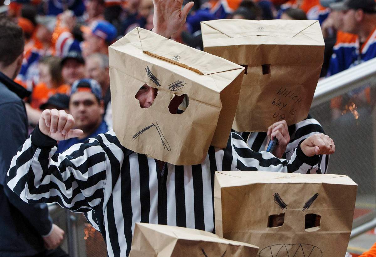 Fans mock the refs during the Anaheim Ducks and Edmonton Oilers game during the first period in game six of a second-round NHL hockey Stanley Cup playoff series in Edmonton on Sunday, May 7, 2017. THE CANADIAN PRESS/Jason Franson.
