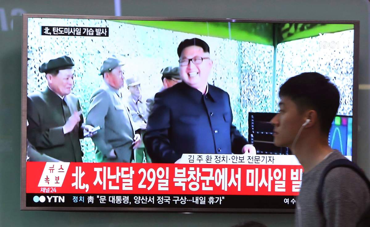 A man passes by a TV news program showing a file image of North Korean leader Kim Jong Un, at the Seoul Railway Station in Seoul, South Korea, Sunday, May 21, 2017. North Korea on Sunday fired a midrange ballistic missile, U.S. and South Korean officials said, in the latest weapons test for a country speeding up its development of nuclear weapons and missiles. The letters read: \”North Korea launched a missile on April 29.\” (AP Photo/Ah