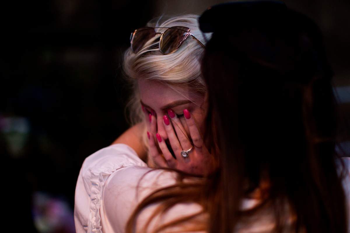 People cry after a vigil in Albert Square, Manchester, England, Tuesday May 23, 2017, the day after the suicide attack at an Ariana Grande concert that left 22 people dead as it ended on Monday night.