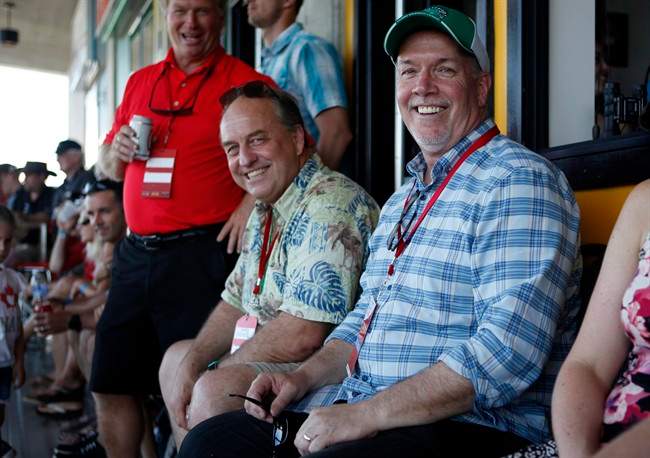 FILE PHOTO: B.C. Green party leader Andrew Weaver and B.C. NDP leader John Horgan take in the final match between Team Canada and New Zealand during cup final action at the HSBC Canada Women's Sevens at Westhills Stadium in Langford, B.C., on May 28, 2017.