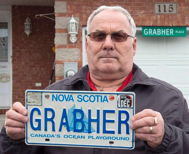 Lorne Grabher displays his personalized licence plate in Dartmouth, N.S., on Friday, March 24, 2017. The Nova Scotia man is fighting to have his last name reinstated on his licence plate.