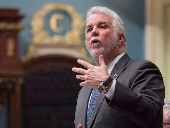 Quebec Premier Philippe Couillard responds to Opposition questions over former premier Jean Charest and Marc Bibeau, during question period Tuesday, April 25, 2017 at the legislature in Quebec City.