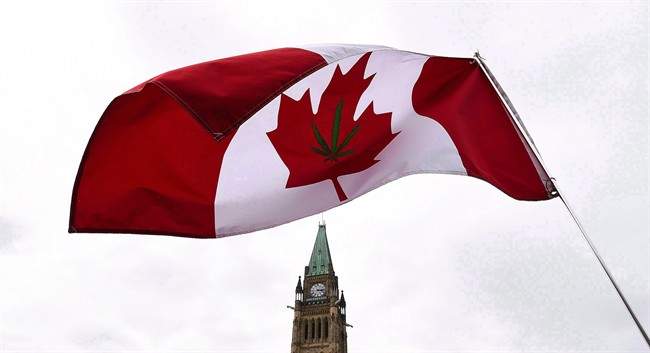 A Canadian flag with a marijuana leaf on it flies during a 4/20 rally on Parliament Hill in Ottawa on April 20, 2017. 