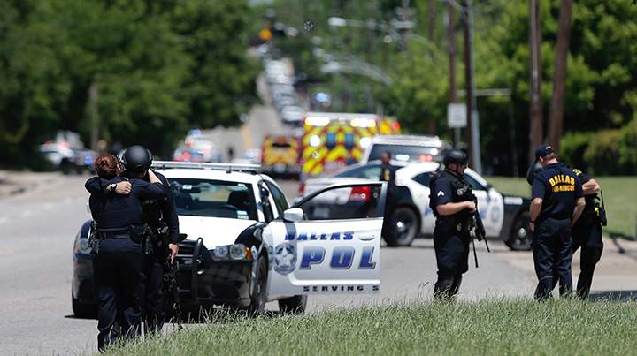 Dallas police officers hug after police responded to a shooting incident in Dallas, Texas, May 1, 2017.  