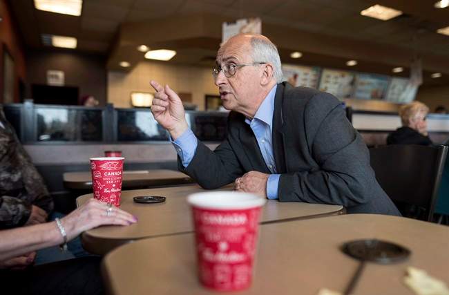 Nova Scotia NDP leader Gary Burrill speaks with people at a Tim Hortons during a campaign stop in Halifax on Friday, May 5, 2017.