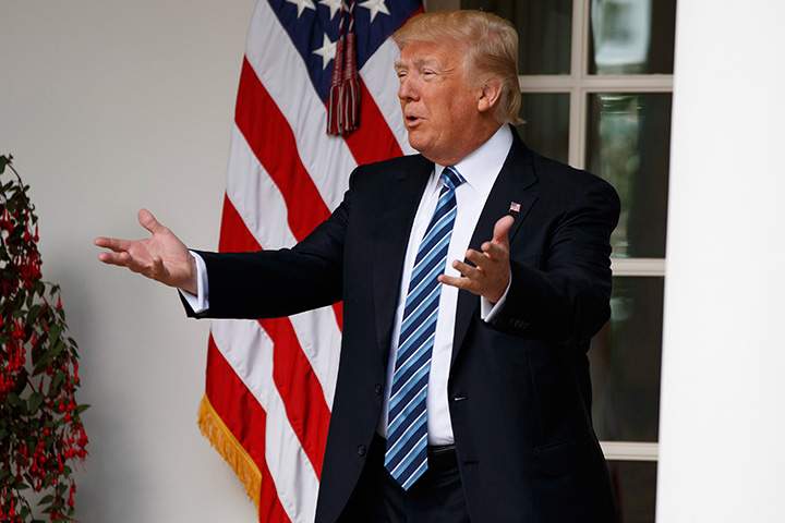 President Donald Trump talks with reporters as he walks to the Oval Office of the White House in Washington, Tuesday, May 2, 2017. 