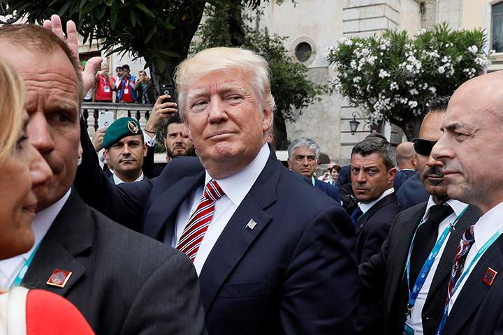 U.S. President Donald Trump waves to onlookers as he attends the G7 Summit in Taormina, Sicily, Italy, May 26, 2017. 