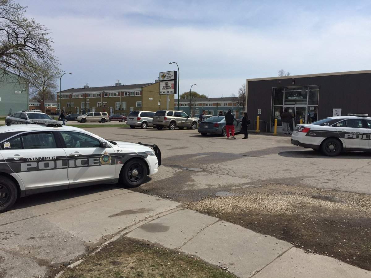 Police cars monitor a situation at the Indian & Metis Friendship Centre, where a man barricaded himself in a room.