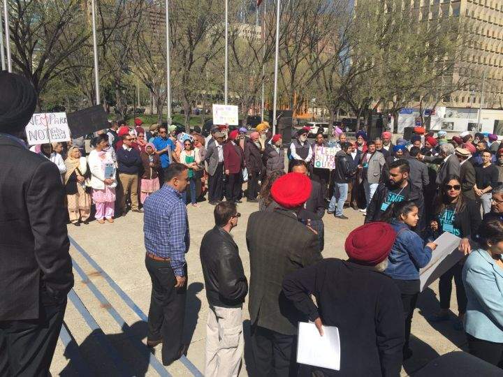 Some 100 people gathered outside city hall on Monday to protest a proposed development next to the Genesis Centre in northeast Calgary.