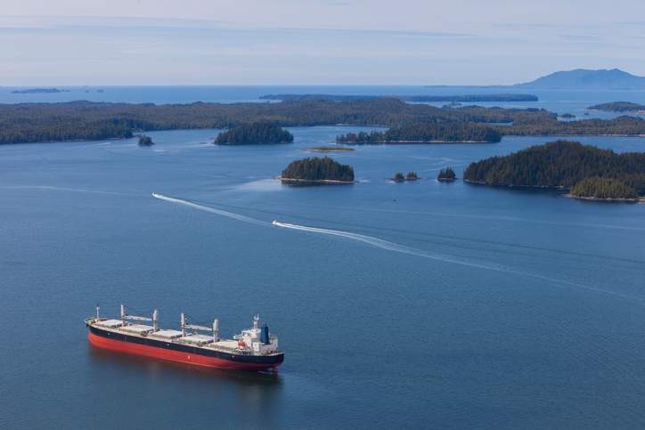 The North Coast of British Columbia near Prince Rupert with a cargo ship in the harbour.