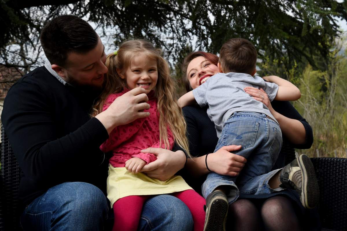 Parents hold onto their children