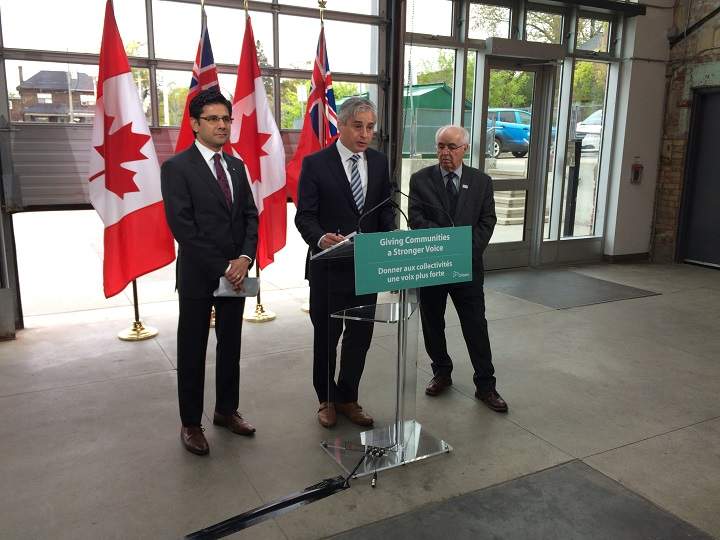 Municipal Affairs Minister Bill Mauro (centre) and Attorney General Yasir Naqvi (left) make an announcement at Artscape Wychwood Barns in Toronto on May 16, 2017.