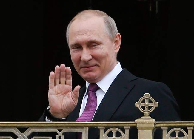 In this May 25, 2017 file photo, Russian President Vladimir Putin greets believers and participants as he visits the Sretensky Monastery to take part in a ceremony consecrating a new temple in Moscow. 