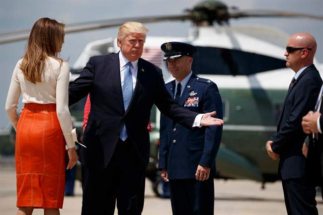 President Donald Trump and first lady Melania Trump with Col. Casey D. Eaton, Commander, 89th Airlift Wing, Andrews Air Force Base prepares to board Air Force One at Andrews Air Force Base, Md., Friday, May 19, 2017, for his first international trip as president.