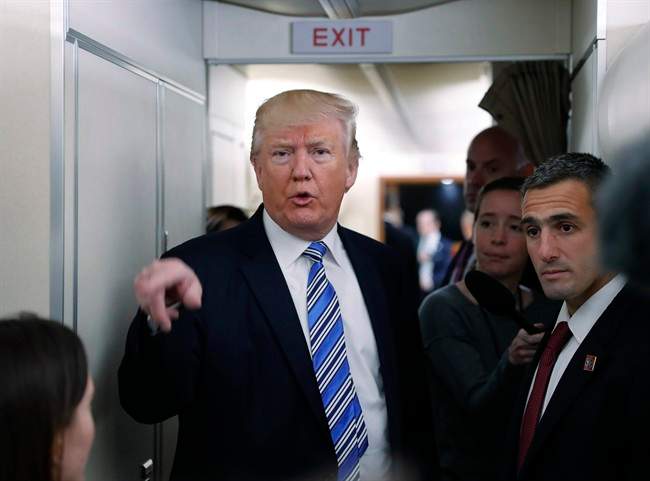 President Donald Trump speaks to members of the media aboard Air Force One before his departure from Andrews Air Force Base, Md., Saturday, May 13, 2017. 