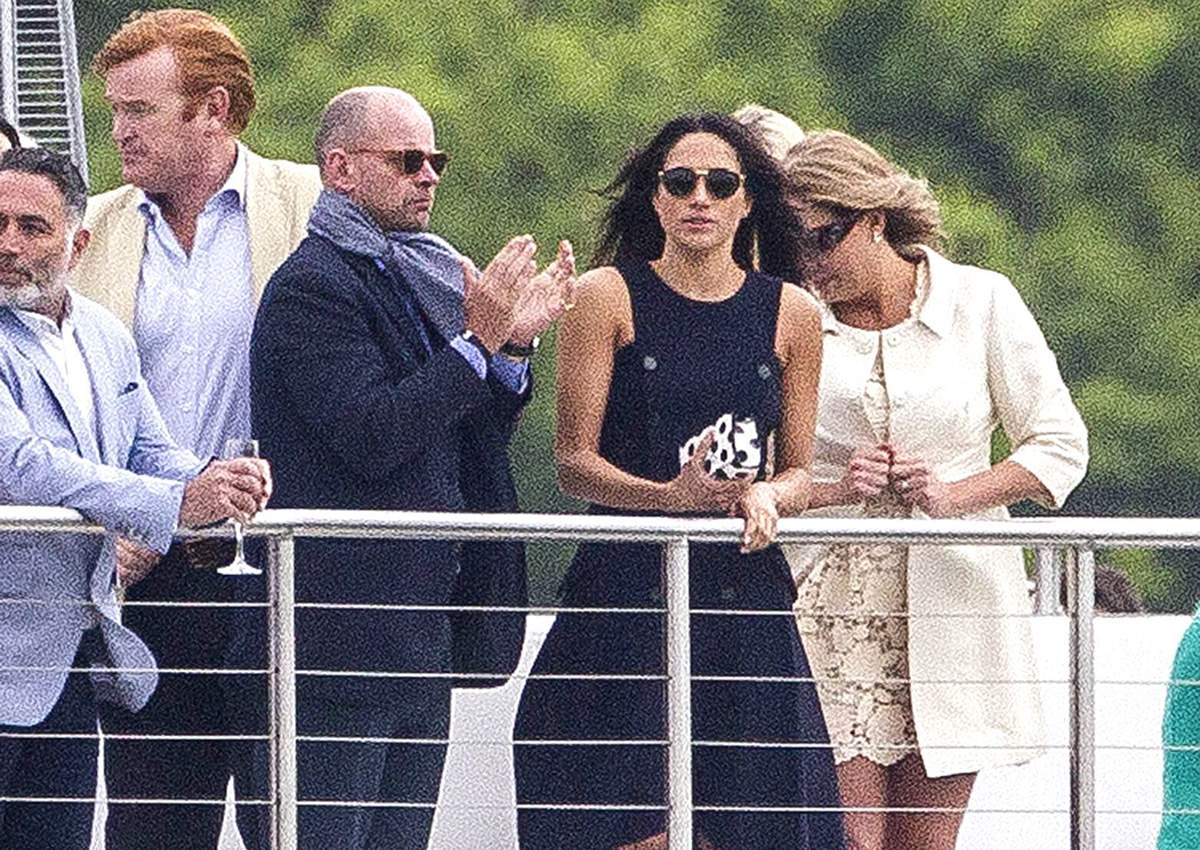 Meghan Markle watches Prince Harry during the presentations at the Audi Polo Challenge.