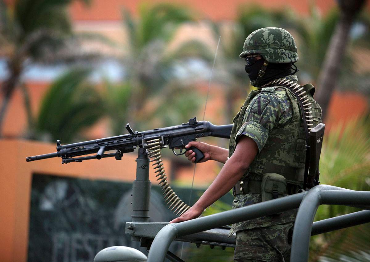 FILE PHOTO: A Mexican army soldier mans a gun on top of a vehicle while guarding the perimeter around the site of a state prosecutors convention in the Gulf port city of Veracruz, Mexico, Thursday Sept. 22, 2011.
