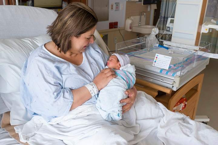 Dalia Abd Almajed holds her newborn son, Abbas.