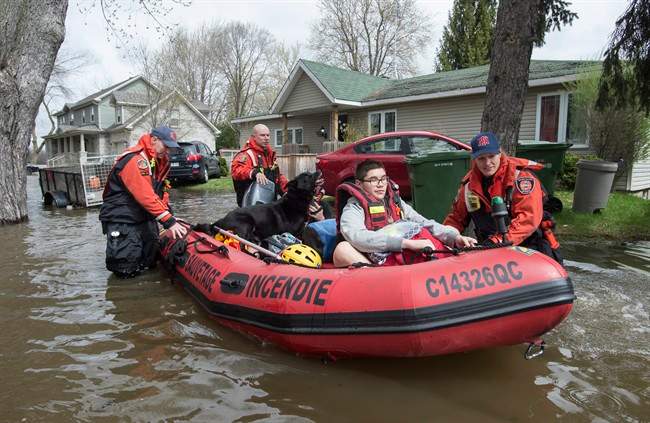Residents are evacuated from their homes following an overnight flash flooding Wednesday, May 3, 2017 in Montreal.
