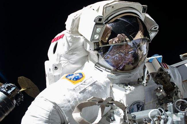 Astronaut Peggy Whitson is pictured with the Orbital ATK Cygnus resupply ship behind her during a spacewalk on May 12, 2017.