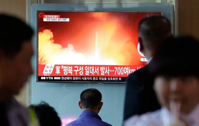 People watch a TV news program showing a file image of a missile launch conducted by North Korea, at the Seoul Railway Station in Seoul, South Korea, Sunday, May 14, 2017.