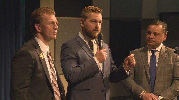 Mile Ellis (left), Derek Fildebrandt (centre) and Prab Gill (right) speak at a town hall in Leduc, Alta. on May 17, 2017.