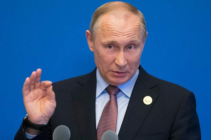 Russian President Vladimir Putin gestures while speaking to the media on May 15, 2017.