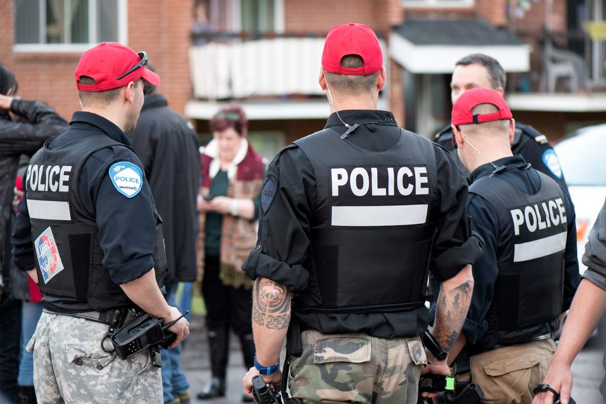 Montreal police officers help flood victims in Île Bizard in Montreal's West Island.