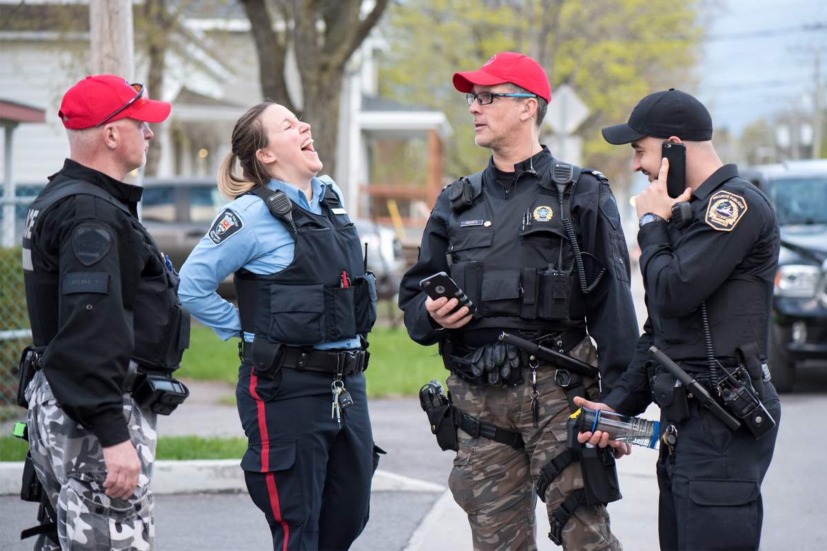 Montreal police officers help flood victims in Île Bizard in Montreal's West Island.