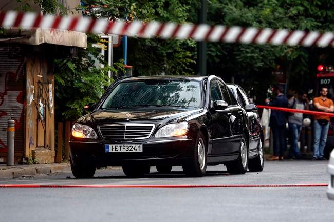 A car in which a device went off, on a central street, in Athens, Thursday, May 25, 2017. Greek police say former Prime Minister Lucas Papademos has been wounded in an explosion in a car in central Athens.