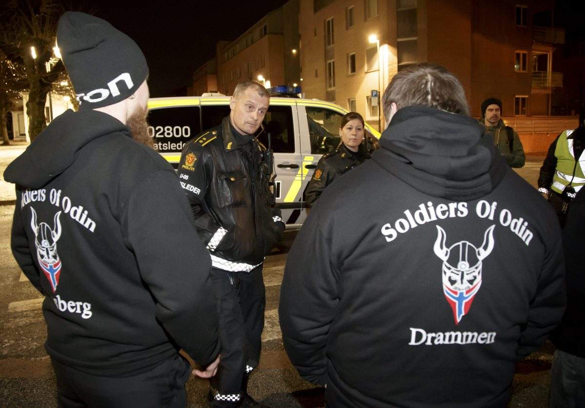 Members of the 'Soldiers of Odin' are checked by Norwegian police for their ID and if they are carrying any weapons, while on patrol in the streets of Drammen, Norway, overnight 21 February 2016. 