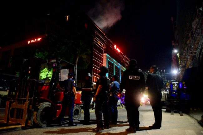 Armed police are deployed outside the Resorts World Manila 

after gunfire and explosions were heard inside the building. Several people were injured before officers gained control of the situation early on June 2, 2017.
