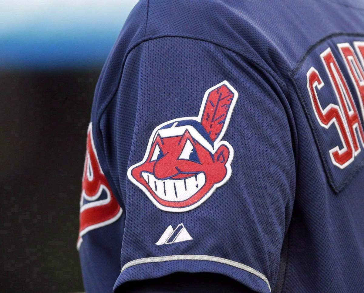 In this April 8, 2014 photo, the Cleveland Indians Chief Wahoo logo is shown on the uniform sleeve of third base coach Mike Sarbaugh during a baseball game against the San Diego Padres in Cleveland, Ohio. Ontario's human rights tribunal is considering hearing a complaint that seeks to bar the Cleveland Indians from being able to use their team name or wear specific logos at major league baseball games played in Toronto.