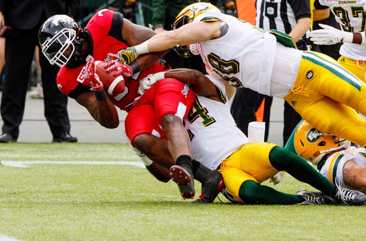 Calgary Stampeders Jerome Messam (33) carries the ball to the end zone under pressure from Edmonton Eskimos e during first half CFL pre-season action in Edmonton, Alta., on Sunday June 11, 2017. THE CANADIAN PRESS/Amber Bracken