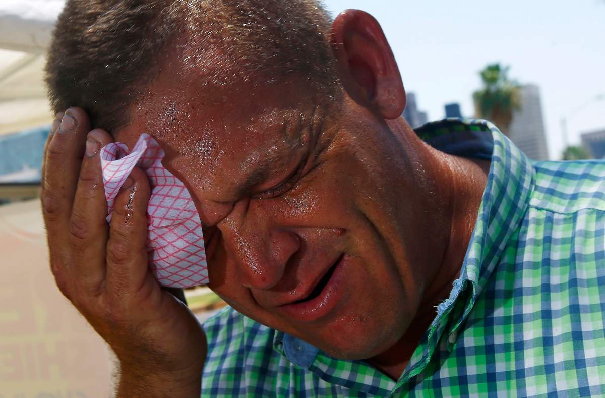 Steve Smith wipes sweat from his face as temperatures climb to near-record highs in Phoenix on Monday, June 19, 2017.