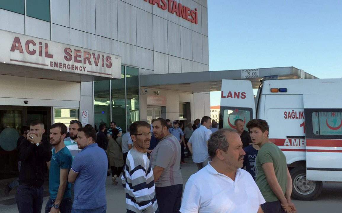 People wait outside a hospital after where the victims were taken.