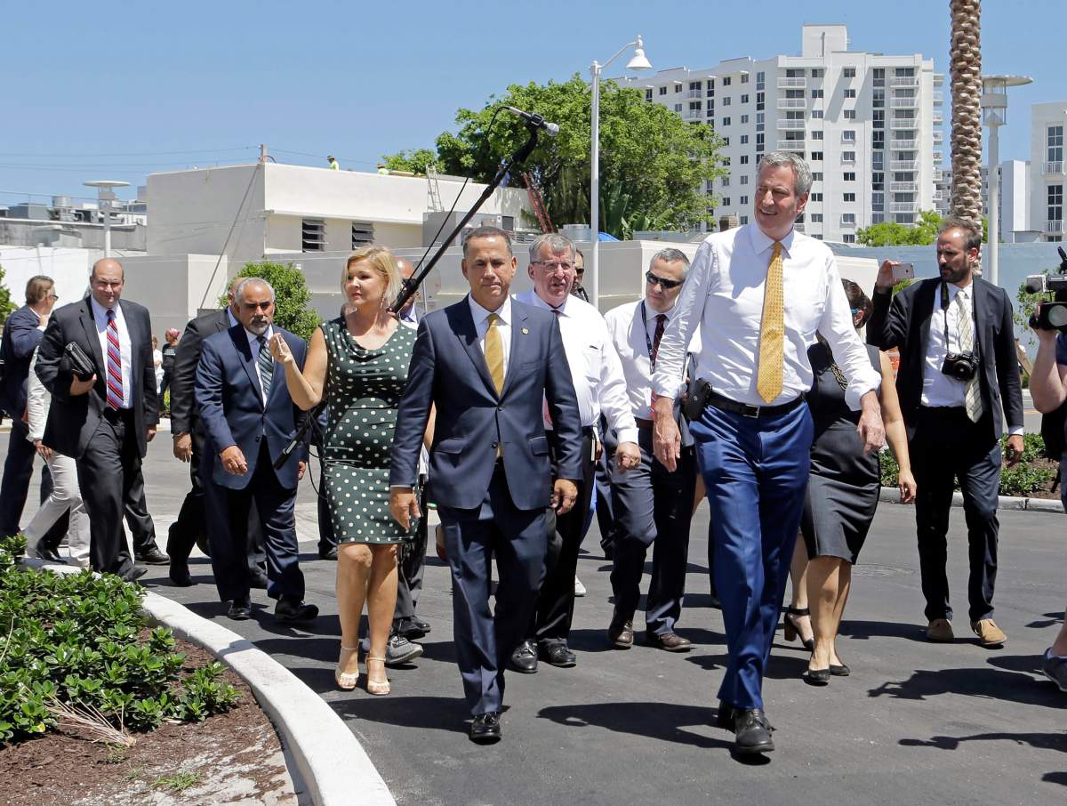 Miami Beach Mayor Philip Levine, foreground left, and New York City Mayor Bill de Blasio, foreground right on Friday, June 23, 2017, in Miami Beach, Fla.  