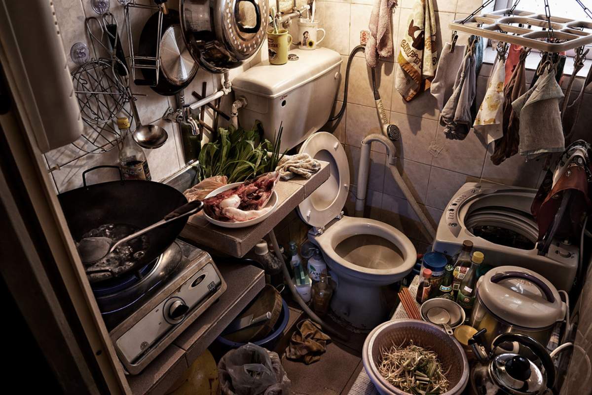A toilet shares space with the kitchen in this Hong Kong home.