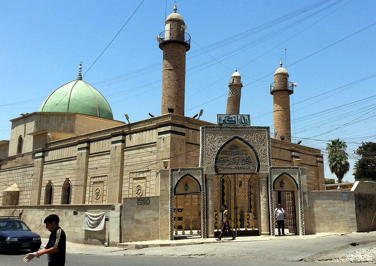 People walk in front of the Al-Noori Al-Kabeer mosque in Mosul, Iraq, 09 July 2014 (reissued 21 June 2017). 