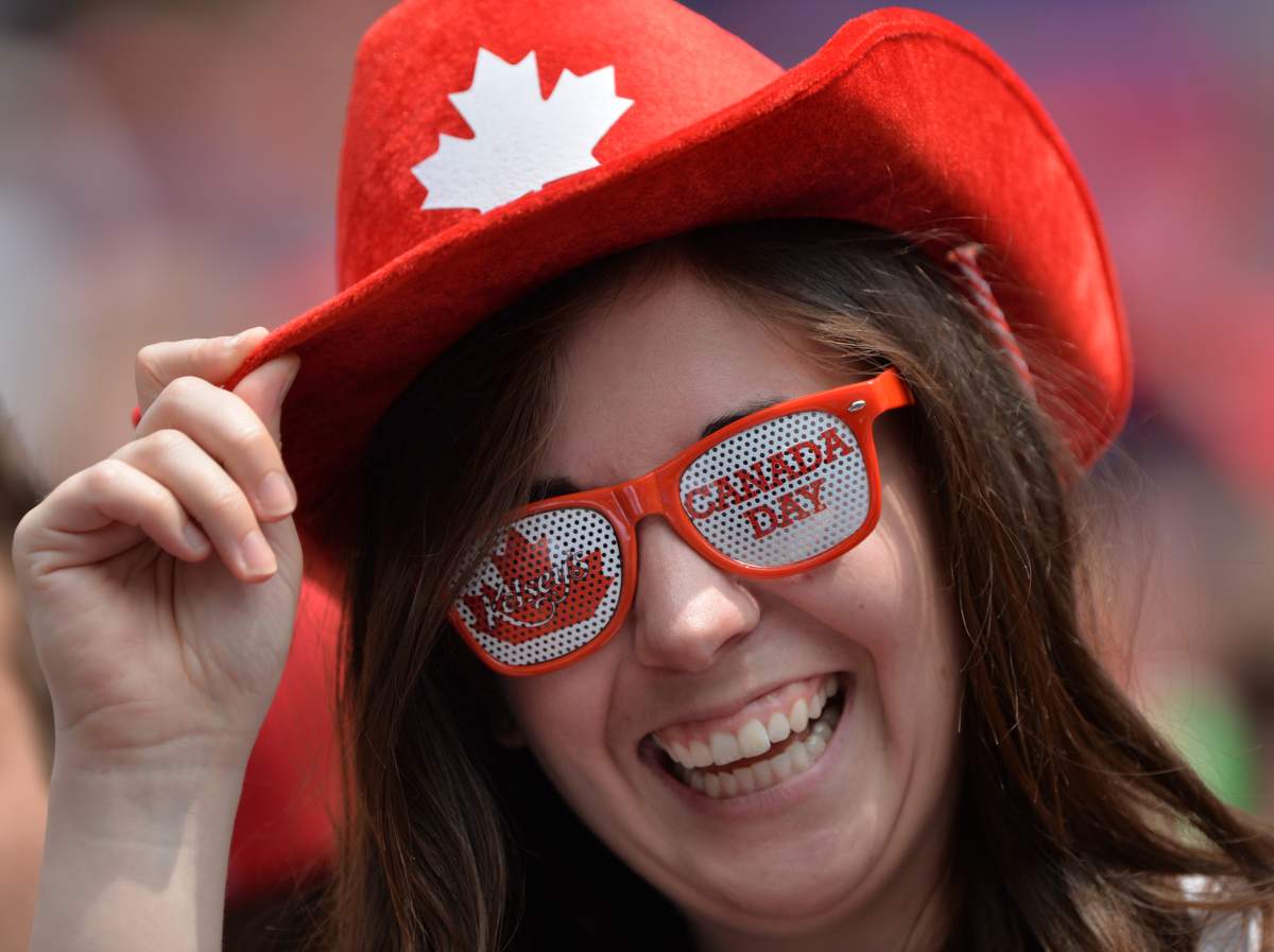 Kim McGinnin, of Brantford, takes in the Toronto Blue Jays game in 2013. Toronto is one of the top places Canadians are looking to travel to for this year's Canada Day 150 celebrations.