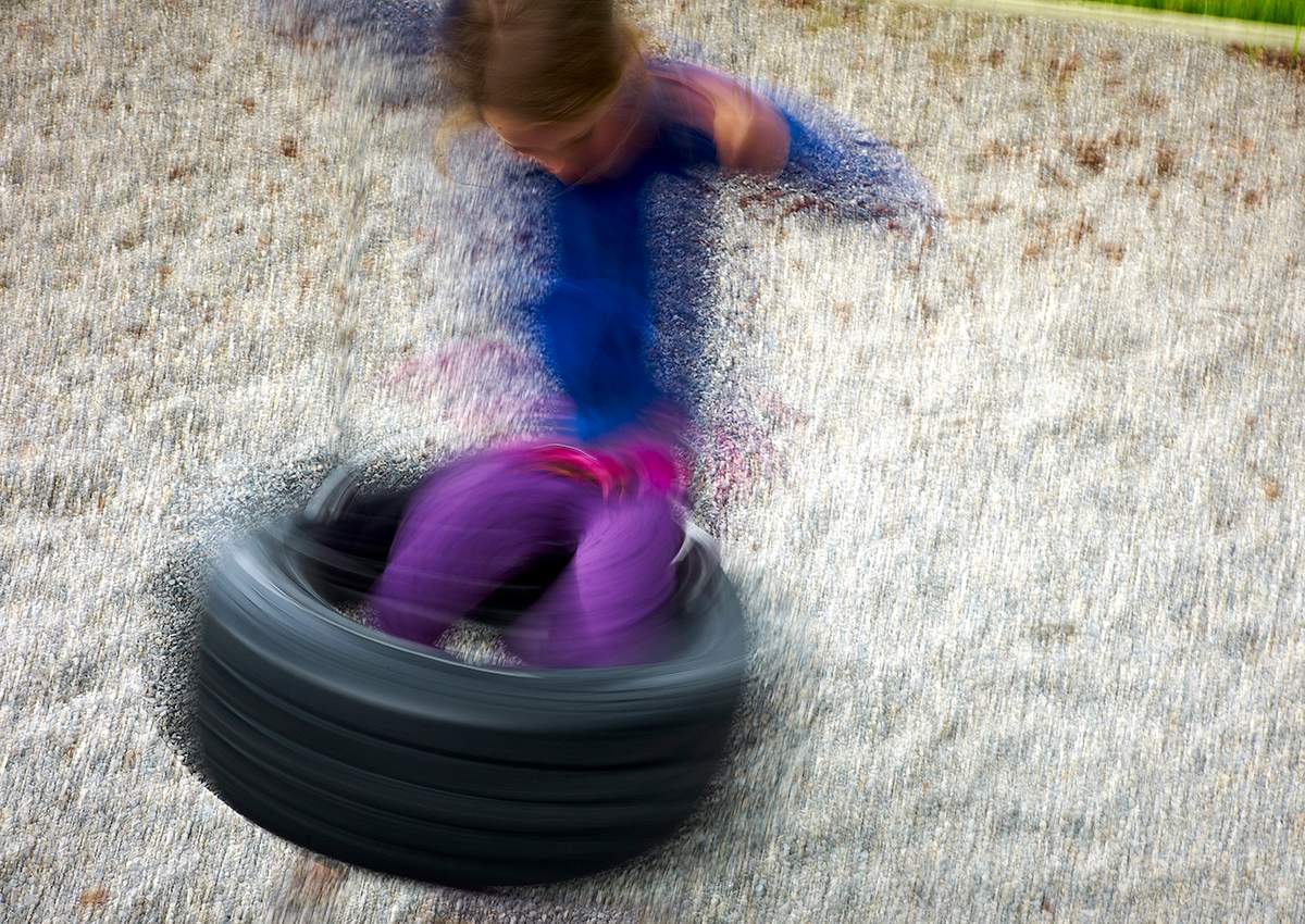 FILE PHOTO: A child plays on a tire swing at a playground Alberta.