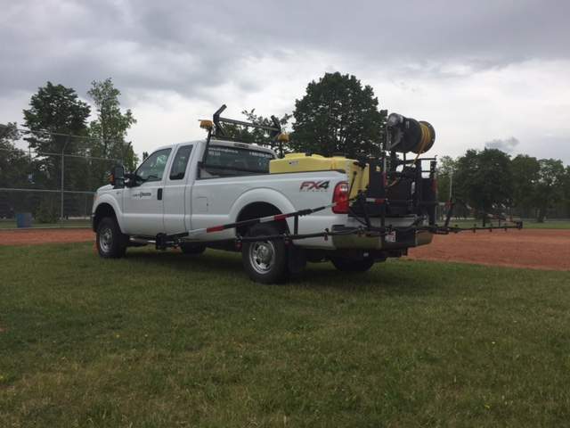 City truck spraying dandelions