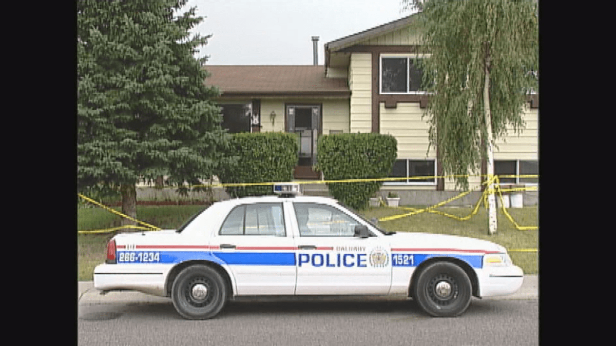 Police car parked outside the home of Clifford Trusty.  He was found stabbed to death in his Fonda Drive S.E. home in September 2003.