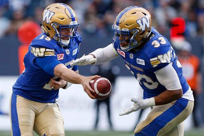 Winnipeg Blue Bombers quarterback Matt Nichols (15) hands off to Andrew Harris (33) during the first half of CFL action against the Edmonton Eskimos, in Winnipeg on June 15, 2017. 