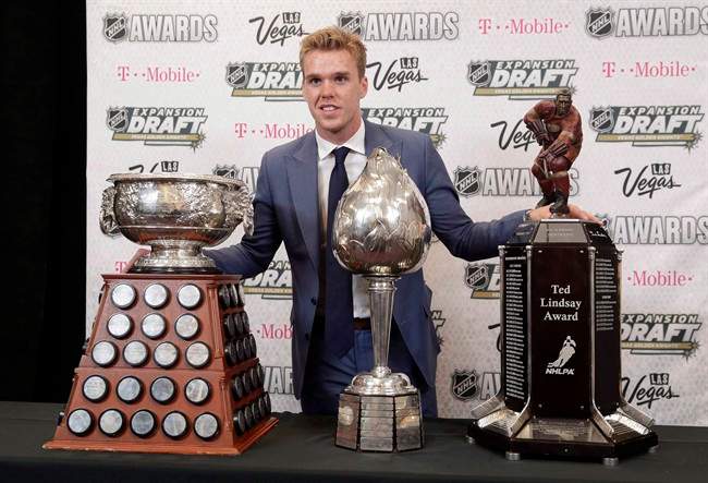 Connor McDavid of the Edmonton Oilers poses with the Art Ross Trophy, left, the Hart Memorial Trophy, center, and the Ted Lindsay Award after winning the honors during the NHL Awards, Wednesday, June 21, 2017, in Las Vegas. 
