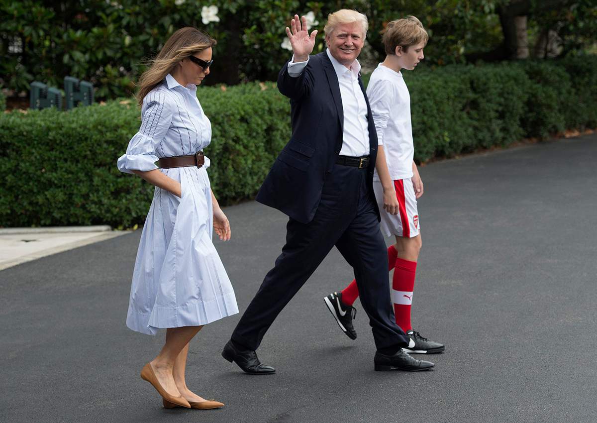 Donald Trump walks to Marine One with first lady Melania and their son Barron, as they depart the White House for Camp David.
